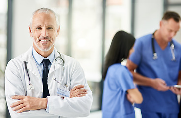 Image showing Healthcare, smile and portrait of senior doctor with arms crossed, pride and support in hospital. Health care, happiness and expert medicine, confident and happy man, medical professional in clinic.