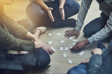 Image showing Hands, business people and puzzle in circle, solution and teamwork for problem solving, planning and games. Group, together and innovation with support, synergy and team building on office floor