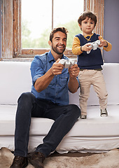 Image showing Family, father and son on a sofa, video game and competition with bonding, loving or relax at home. Parent, happy dad or boy on a couch, playing and gamers in the living room, happiness or connection