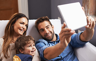 Image showing Video call, tablet and family on social media in a home together and relax using the internet or an online app. Living room, website and parents with kid or child in happiness and smile for a picture