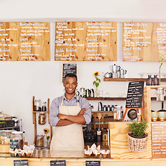 Image showing Portrait, black man and waiter with arms crossed in cafe with pride for career or job. Barista, smile and confidence of African person from Nigeria as restaurant owner, small business and coffee shop