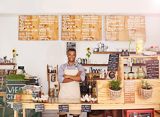 Image showing Black man, portrait and owner with arms crossed in cafe with pride for career or job. Barista, smile and confidence of African person from Nigeria in restaurant, small business and coffee shop.