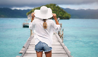 Image showing Island, ocean and back of woman on deck for holiday, summer vacation and weekend getaway in Maldives. Traveling, tropical villa and female person on luxury resort for relax, happiness and adventure