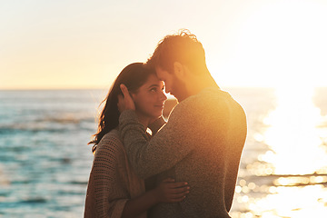 Image showing Sunset, beach and couple touching face for relaxing, bonding and quality time on romantic date. Nature, love and man and woman embrace for anniversary or honeymoon on holiday, weekend and vacation