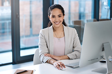 Image showing Success, confidence and portrait of a businesswoman in the office while working on a computer. Happy, smile and professional female employee working on a corporate project on a pc in the workplace.