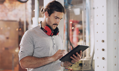 Image showing Tablet, industry and planning with a man in a workshop for manufacturing, production or metal work. Logistics, construction and technology with an industrial engineer working in a factory or plant