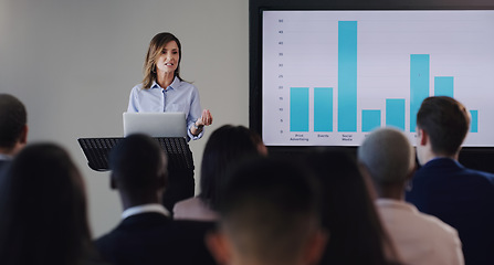 Image showing Woman speaker, presentation or business screen of graphs at seminar, workshop or training. Professional men, women or conference with a podium for learning, knowledge and discussion for sales growth