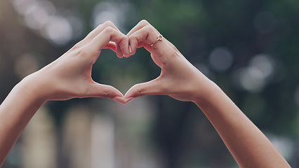 Image showing Closeup, hands and woman with a heart shape, city and solidarity with support, care and review. Zoom, female person and girl outdoor, symbol and love with feedback, motivation and sign with emoji