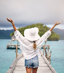 Image showing Island, travel and back of woman on deck for holiday, summer vacation and weekend in Maldives. Traveling, tropical ocean and female person on luxury resort for relaxing, happiness and adventure