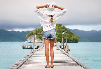 Image showing Travel, ocean and back of woman on island deck for holiday, summer vacation and weekend in Maldives. Traveling, tropical villa and female person on luxury resort for relaxing, freedom and adventure