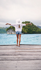 Image showing Island, tropical ocean and back of woman on deck for holiday, summer vacation and getaway in Maldives. Travel, relax and female person on luxury resort for tourist destination, freedom and adventure