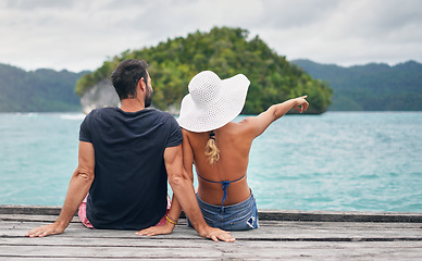 Image showing Ocean, vacation and couple together on deck, dock or sitting on boardwalk to relax and enjoy the sea, water or landscape. People, man and woman on holiday, summer travel or tropical date in Bali