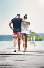 Image showing Couple, walking and beach deck on holiday with freedom and love in summer in Thailand. Tropical nature, sea and back of people on a boardwalk walk in the sun on vacation break by the ocean and water