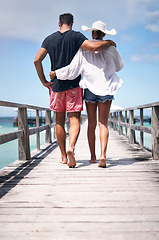 Image showing Couple legs, walking and beach deck on a tropical island on vacation with freedom by sea. Ocean, relax and walk of a man back and woman together with love in summer on a holiday outdoor in sun