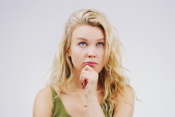 Image showing Young woman, thinking and remember in studio with ideas, memory and focus by gray background. Girl, model and think with doubt, confused and decision for choice, planning and question with mindset