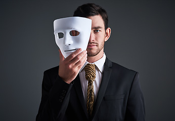 Image showing Two faces, holding mask and businessman portrait in a studio with serious face with secret and fraud. Worker or corporate criminal with rope tie showing identity theft or liar in business suit mockup