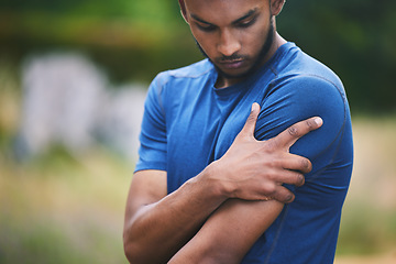 Image showing Sports, fitness and man with pain in shoulder after workout, exercise and marathon training outdoors. Medical emergency, health and male person with muscle strain, arm injury and joint ache in park