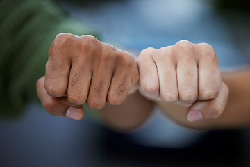 Image showing Protest, fist and people in solidarity for justice, human rights and democracy on blurred background. Hands, diversity and men united for peace, change and power, transformation or community activism