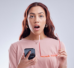 Image showing Portrait, connection and woman with a smartphone, surprise and communication against a studio background. Face, female person or model with shock, cellphone and mobile app with network and connection