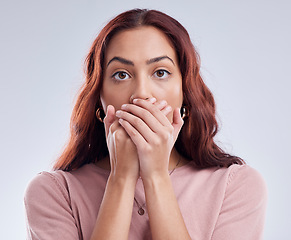 Image showing Portrait, secret and woman with a surprise, cover mouth and announcement against a studio background. Face, female person and model with gossip, shock and hands on lips with worry, reaction and omg