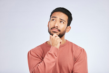 Image showing Face, man and thinking of idea in studio or planning, decision and choice with white mockup background. Asian male, model and curious with doubt, questions or thoughtful guy, confused or remember