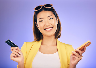 Image showing Phone, credit card and portrait of a woman in a studio for online shopping with a positive mindset. Happy, smile and Asian female model with internet banking for paying bills by a purple background.