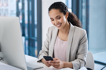 Image showing Young business woman, texting and phone in office with smile, email communication and chat with online date. Businesswoman, smartphone and typing for contact, networking and social media app at desk