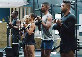 Image showing Weightlifting, fitness and people with kettlebell in gym for training, exercise and workout class. Teamwork, body builder and serious men and women lift weights for challenge, wellness and strength