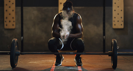 Image showing Weightlifting, powder and black man with barbell in gym for training, exercise and serious workout. Sports, strong muscle and male body builder lifting weights for challenge, wellness and strength