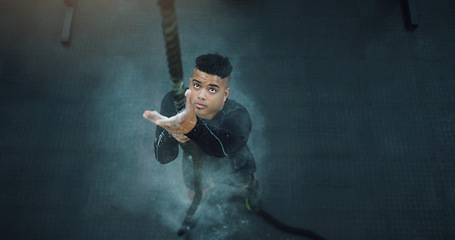 Image showing Rope climbing, fitness and man at gym from above for training, performance and intense cardio on black background. Top view, climb and male with ropes, resilience and mindset during power workout