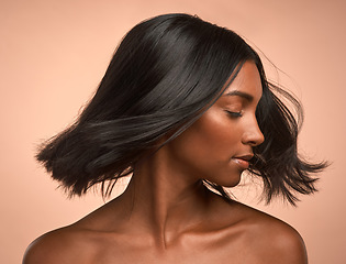 Image showing Hair care, beauty and young woman in studio with keratin, healthy or brazilian salon treatment. Wellness, cosmetic and female model with motion for shiny, clean and soft hairstyle by brown background