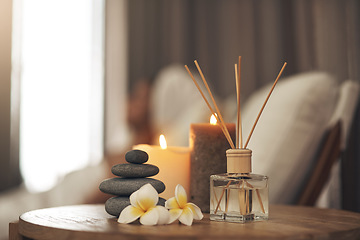 Image showing Spa, aromatherapy and candles on table for zen, calm and peace to relax for health and wellness. Stones, flowers and diffuser for self care, holistic massage and hospitality at a beauty salon