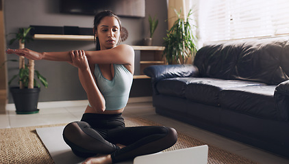 Image showing Stretching, Indian woman and laptop for online yoga on living floor for training, balance or healthy lifestyle. Arm, stretch and female person start fitness tutorial for pilates or meditation workout