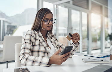 Image showing Business, cellphone and woman with a credit card, online shopping and ecommerce in a modern office. Female person, employee and agent with payment, smartphone and internet connection for transaction