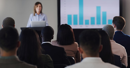 Image showing Speaker, conference and business woman with graphs at a seminar, workshop or training. Professional men and women at a presentation with podium for learning, knowledge and discussion for sales growth