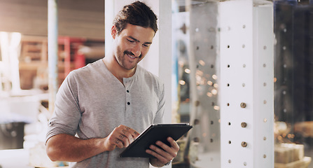 Image showing Tablet, industry and planning with a man in a factory for manufacturing, production or metal work. Logistics, construction and technology with an industrial engineer working in a workshop or plant