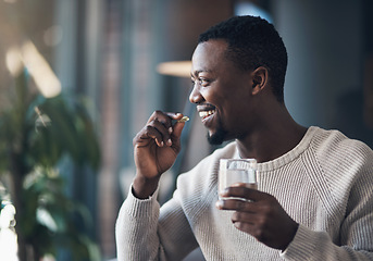 Image showing Black man, pill or medicine and a glass of water in a house for health and wellness with a smile. Happy male person drinking pills, supplements or medication for healthcare, vitamins and energy