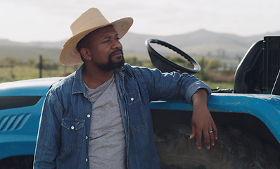 Image showing Farming, vision and a black man with a tractor on a farm for agriculture growth and sustainability. Idea, planning and an African farmer in the countryside with ideas for sustainable business