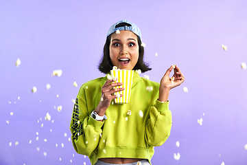 Image showing Surprise, wow and woman with popcorn for a movie or streaming service or cinema and in studio against a purple background. Video, entertainment and film or television or omg and snack on mock up