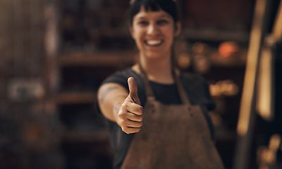 Image showing Thumbs up, factory and woman blacksmith in workshop for industry, manufacturing and manual labor. Industrial warehouse, welding and female person with hand sign for steel, iron and metal production