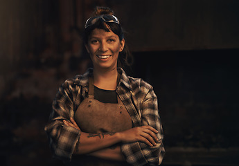 Image showing Woman blacksmith, portrait and smile in workshop, industrial warehouse or trade with entrepreneurship. Small business owner, female entrepreneur or confident in factory, industry or metalwork artisan