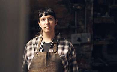 Image showing Woman blacksmith, portrait and workshop at factory, trade or artisan job for entrepreneurship. Small business owner, female entrepreneur or labor in manufacturing, industrial warehouse or metalwork