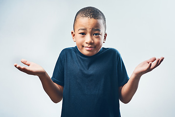 Image showing Shrugging, doubt and portrait of a child with a decision isolated on a white background in a studio. Confused, young and a little boy with a gesture for choice, indecision and confusion or uncertain