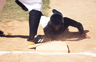 Image showing Baseball player safe, running and man on a softball base at a game with training and dirt. Dust, sport and male athlete outdoor on a field with exercise and run to box of runner on sand with cardio