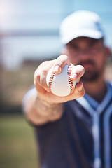 Image showing Hand holding baseball, closeup and man for sports, field and training with blurred background in sunshine. Softball player, sport and zoom of ball for training, fitness and workout for competition