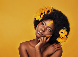 Image showing Makeup, sunflower and black woman thinking in studio for beauty, wellness and treatment on yellow background. Flower, skincare and African female model relax while contemplating eco friendly cosmetic