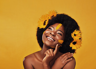 Image showing Thinking, beauty and happy black woman with sunflower in studio for makeup or wellness on yellow background. Flower, skincare and African lady model smile, relax or contemplate eco friendly treatment