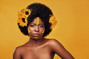 Image showing Makeup, sunflower and paint with portrait of black woman in studio for beauty, creative or spring. Natural, cosmetics and floral with face of model on yellow background for art, self love or glow