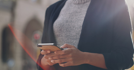 Image showing Hands, phone and business woman with closeup in city, texting and networking for email communication on web. Businesswoman, smartphone or typing in metro street for social media app, chat and contact