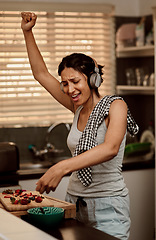 Image showing Music headphones, singing and woman cooking with strawberry. Sing, kitchen and female person making snack with fruit for healthy nutrition while dancing to audio, sound and radio podcast in home.